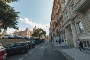 a street with cars parked on the side of a building at Washington Apartment in Prague