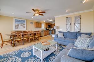 a living room with a blue couch and a table at Oceanfront Murrells Inlet Home with Beach Access! in Myrtle Beach