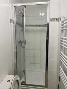 a bathroom with a glass shower with a toilet at 36 Park Road Lenton in Nottingham