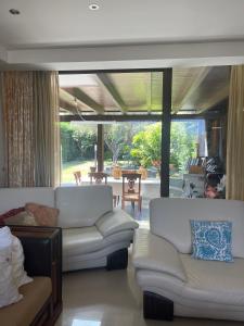 a living room with two white couches and a patio at Fenix Villa in Noicattaro