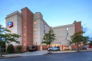 a building with a car parked in front of it at Fairfield Inn by Marriott New York LaGuardia Airport/Flushing in Queens