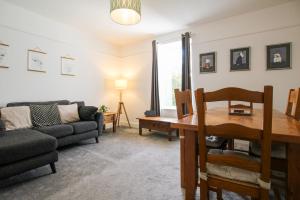 a living room with a couch and a table at Fairways View - Spacious Apartment - Sleeps 6 - Lovely Views - by Rework Accommodation in Hoylake +22 photos