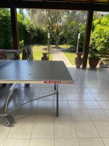 a ping pong table sitting on top of a floor at Fenix Villa in Noicattaro