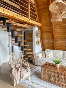 a living room with a couch and a staircase at Zlatar Resort & SPA in Nova Varoš