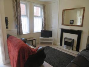 a living room with a fireplace and a television at 29 Lewes Road - Darlington in Darlington