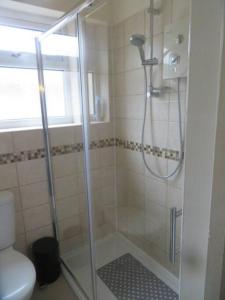a bathroom with a shower with a glass door at 29 Lewes Road - Darlington in Darlington