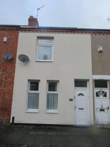 a white house with white doors and windows at 29 Lewes Road - Darlington in Darlington