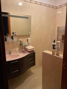 a bathroom with a sink and a mirror at Fenix Villa in Noicattaro +37 photos