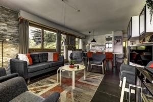 a living room with a couch and a table at Appartement Mont Parrain 4 in La Tzoumaz