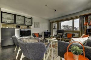 a living room with couches and chairs and a fireplace at Appartement Mont Parrain 4 in La Tzoumaz