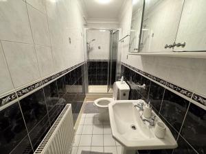 a white bathroom with a sink and a toilet at Perfect for Contractors - Long Term Discounts, Free Parking & Fast Wifi in Wolverhampton