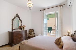 a bedroom with a bed and a dresser and a mirror at Casa Gallo in Alassio