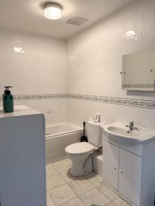 a white bathroom with a toilet and a sink at Perfect for Contractors - Long Term Discounts, Free Parking & Fast Wifi in Wolverhampton