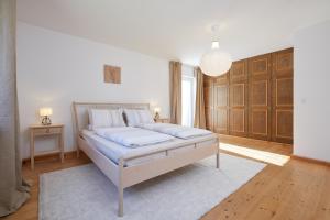 a bedroom with a bed and a pendant light at Ferienwohnung zum Hirschgarten in Krün