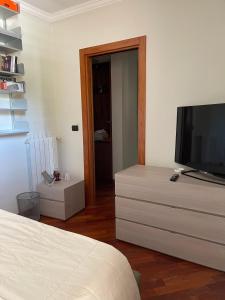 a bedroom with a bed and a television on a dresser at Fenix Villa in Noicattaro