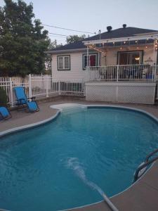 a large swimming pool in front of a house at Guest house with Moroccan style in Gatineau 15 min from heart of Ottawa in Gatineau