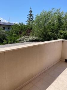a concrete retaining wall with bushes and trees at Fenix Villa in Noicattaro