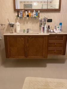 a bathroom vanity with a sink and a mirror at Fenix Villa in Noicattaro
