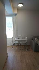 a living room with a table and a couch at Studio Kakolanmäellä in Turku