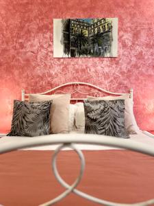 a bedroom with a bed with a red wall at Suite Scarlatti in Naples