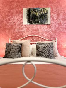 a bedroom with a bed with a red wall at Suite Scarlatti in Naples +85 photos