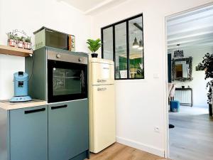 a kitchen with an old stove and a refrigerator at LOASIS - Duplex T4 Hypercentre in Villefranche-sur-Saône