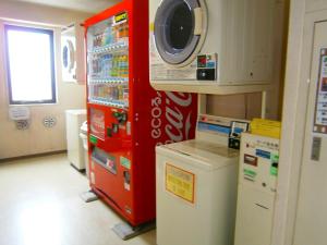 een wasruimte met een wasmachine en een wasmachine bij APA Hotel Miyazaki Miyakonojo Ekimae in Miyakonojo