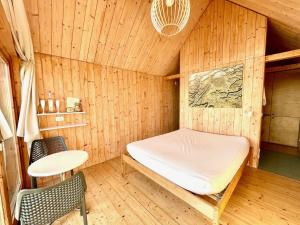 a sauna with a bed and a table and chairs at Lushna 11 Lux Suite at Lee Wick Farm Cottages & Glamping in Clacton-on-Sea