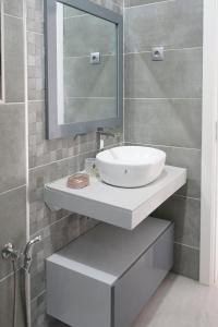 a bathroom with a white sink and a mirror at Charming 2 bdr apt, Palmarejo Grande, Praia - LCGR in Praia