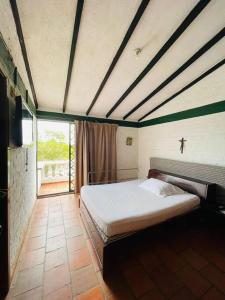 een slaapkamer met een groot bed in een kamer bij finca de descanso y recreacion, fogata,piscina. in Cali