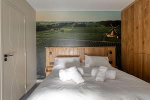 a bedroom with a bed with a view of a vineyard at L'Ardoise, L'Anjou, La Vigne et La Loire in Angers