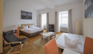 a living room with a couch and a table at Apartment Hotel Konstanz in Konstanz