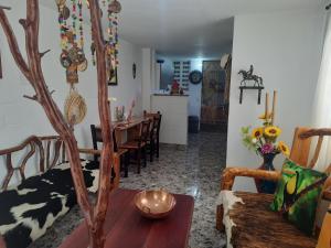 a living room with a table and a dining room at Apartamento Campestre Medellin in Medellín