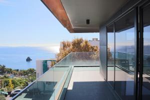 a glass balcony with a view of the ocean at Seaside XXI-10, By OP in Funchal