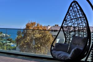 a swing chair sitting on top of a roof at Seaside XXI-10, By OP in Funchal