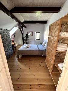 a bedroom with a bed and a stone wall at Loft in Historischer Schmiede in Berlin