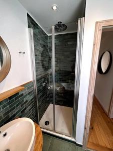 a bathroom with a shower and a sink at Loft in Historischer Schmiede in Berlin