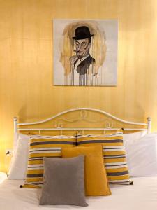 a painting of a man with a hat on a bed at Suite Scarlatti in Naples