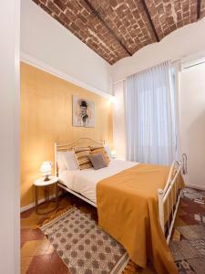 a bedroom with a large bed and a window at Suite Scarlatti in Naples