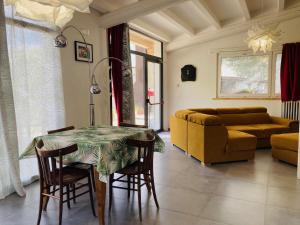 a living room with a table and a couch at La casetta sulle nuvole. in Cammarata