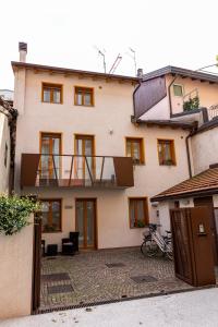 Una gran casa blanca con balcón. en Casetta al centro, en Trento