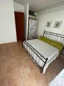 una camera da letto con un letto e un pavimento piastrellato di Acquario a Lido Marini