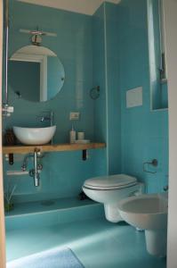 a bathroom with a sink and a toilet and a mirror at QuiSiSana a mare in Castellammare di Stabia +33 photos
