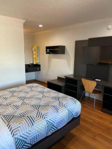 1 dormitorio con cama, escritorio y silla en Motel 6 Sacramento, Ca - Downtown, en Sacramento