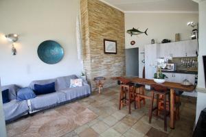 a living room with a couch and a table at Du Bantry 14 in Uvongo Beach
