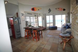 a living room with a table and chairs and the ocean at Du Bantry 14 in Uvongo Beach +9 photos