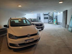 zwei geparkte Autos in einer Garage in der Unterkunft COMPLEJO CRUZ in Alta Gracia
