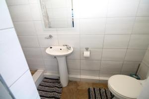 a bathroom with a sink and a toilet at Du Bantry 14 in Uvongo Beach