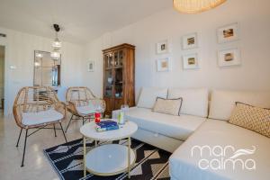 a living room with a white couch and chairs at Apto. Bellavista by MarCalma in Miami Platja