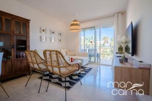 a living room with a couch and a table and chairs at Apto. Bellavista by MarCalma in Miami Platja